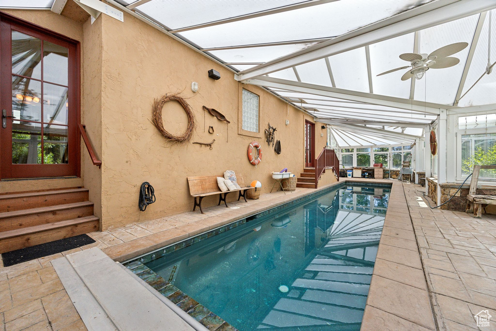 View of swimming pool featuring ceiling fan and a patio