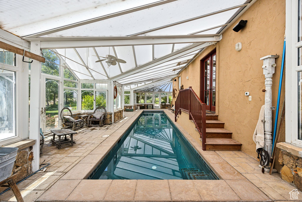 View of swimming pool featuring a patio area and ceiling fan