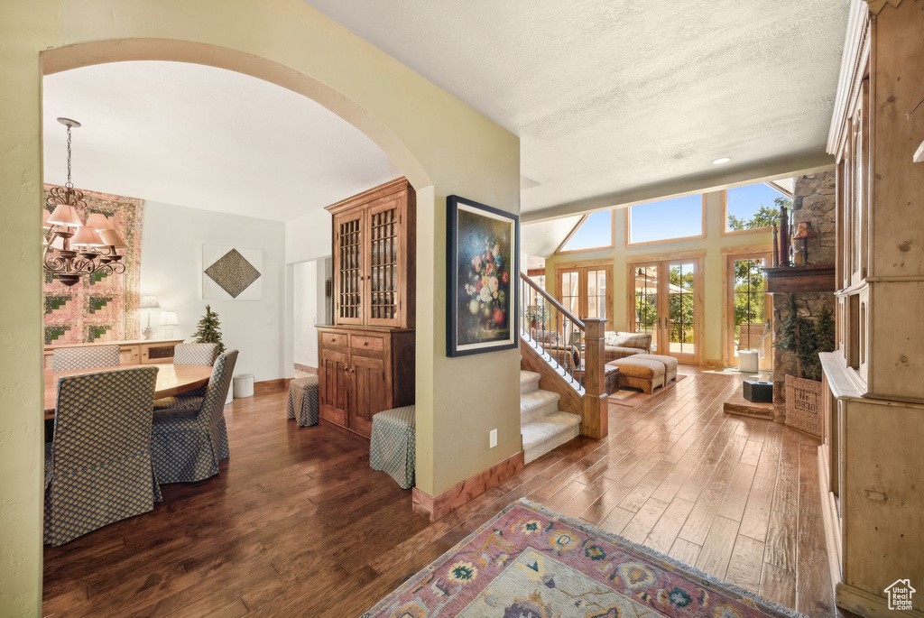 Entrance foyer with a textured ceiling and wood-type flooring