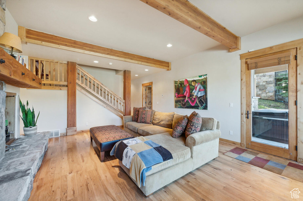 Living room featuring beam ceiling and light hardwood / wood-style flooring