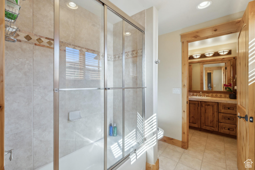 Bathroom with tile flooring, vanity, and toilet