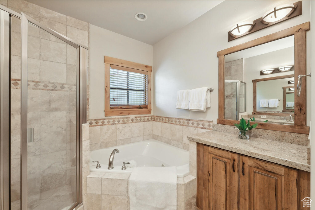 Bathroom featuring independent shower and bath and vanity