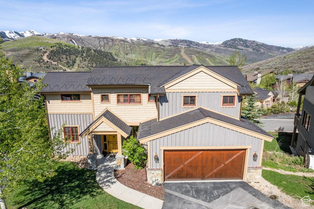 View of front facade with a garage and a mountain view