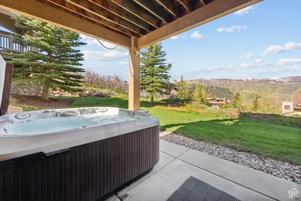 View of terrace featuring a hot tub