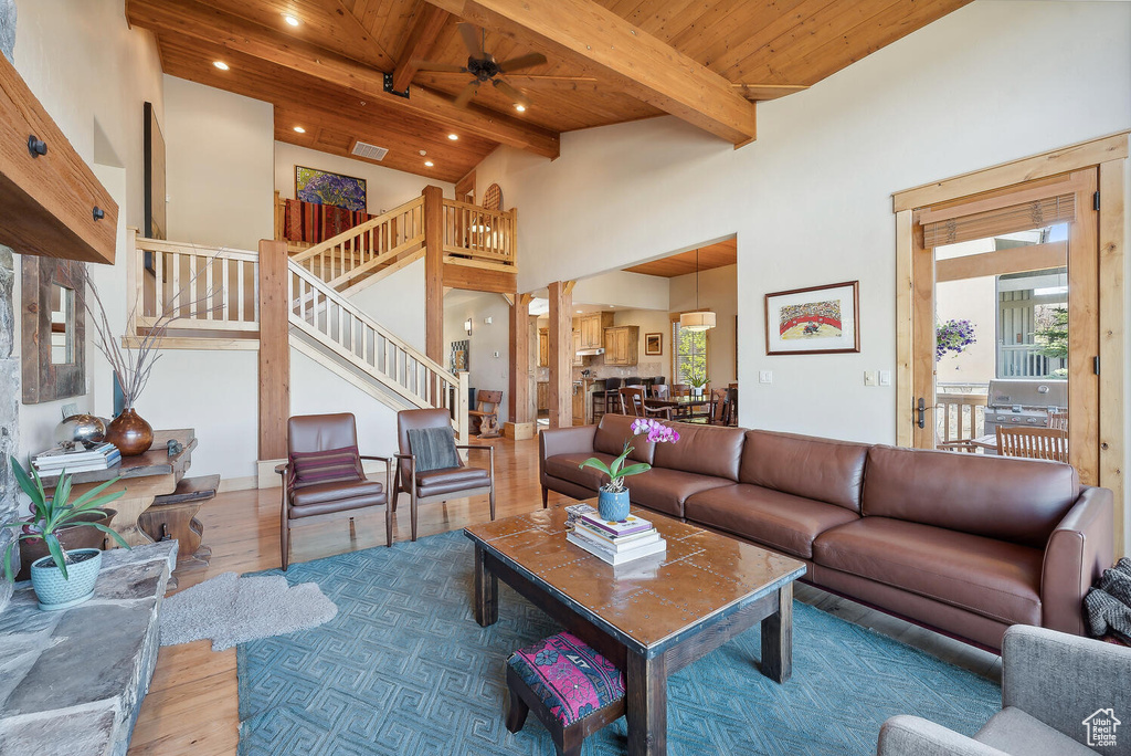 Living room with wooden ceiling, a wealth of natural light, ceiling fan, and hardwood / wood-style floors