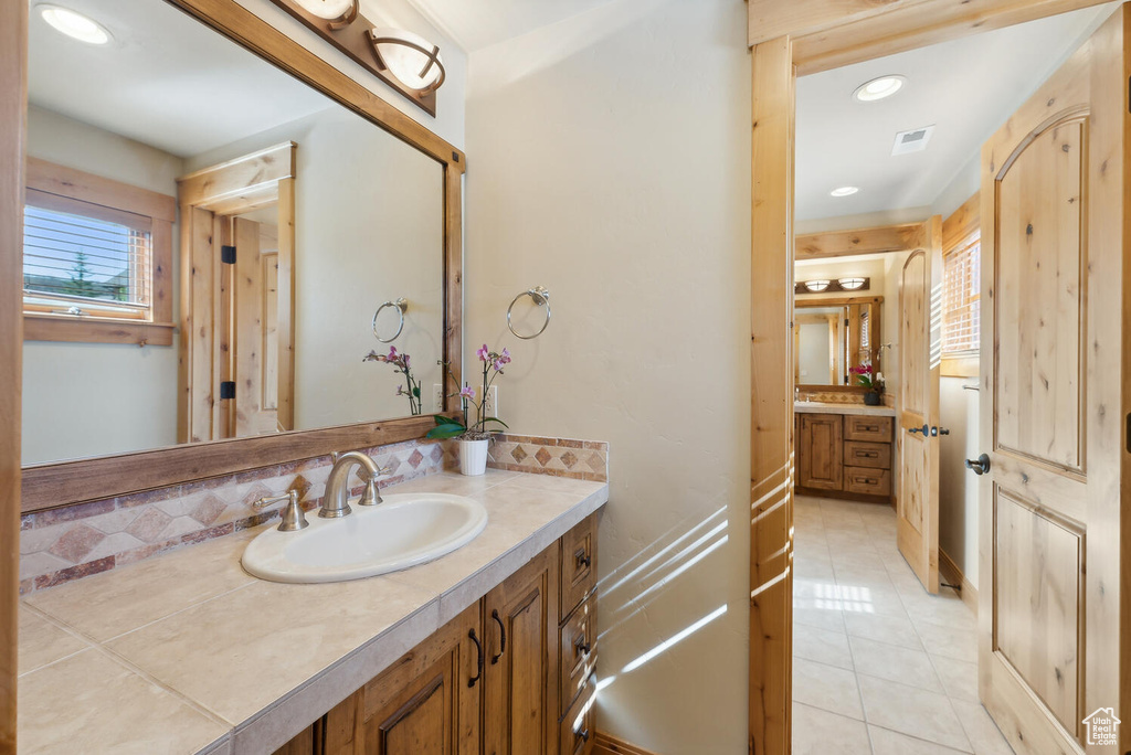 Bathroom with tile flooring and vanity