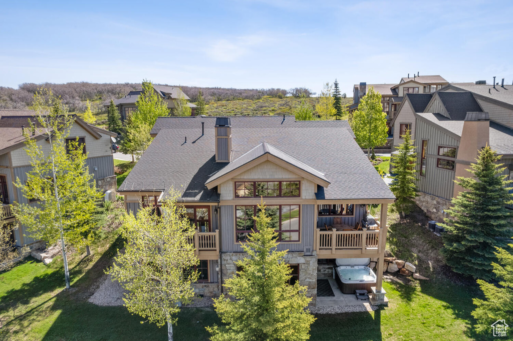 Rear view of property with a yard