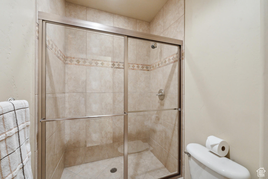 Bathroom featuring walk in shower and toilet