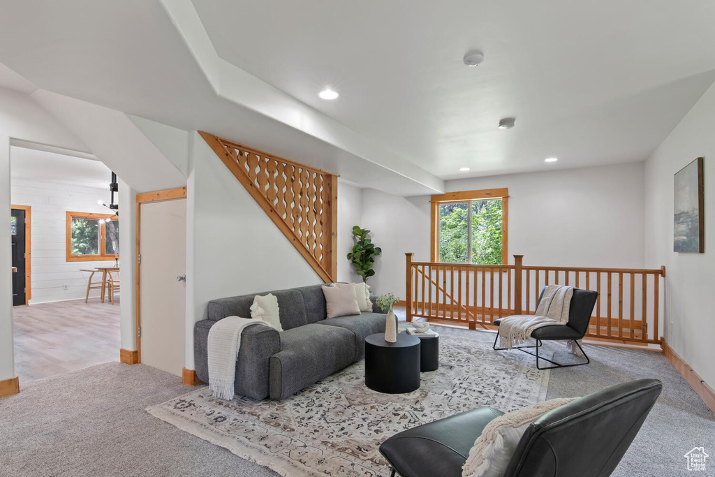 Living room with carpet flooring and a notable chandelier