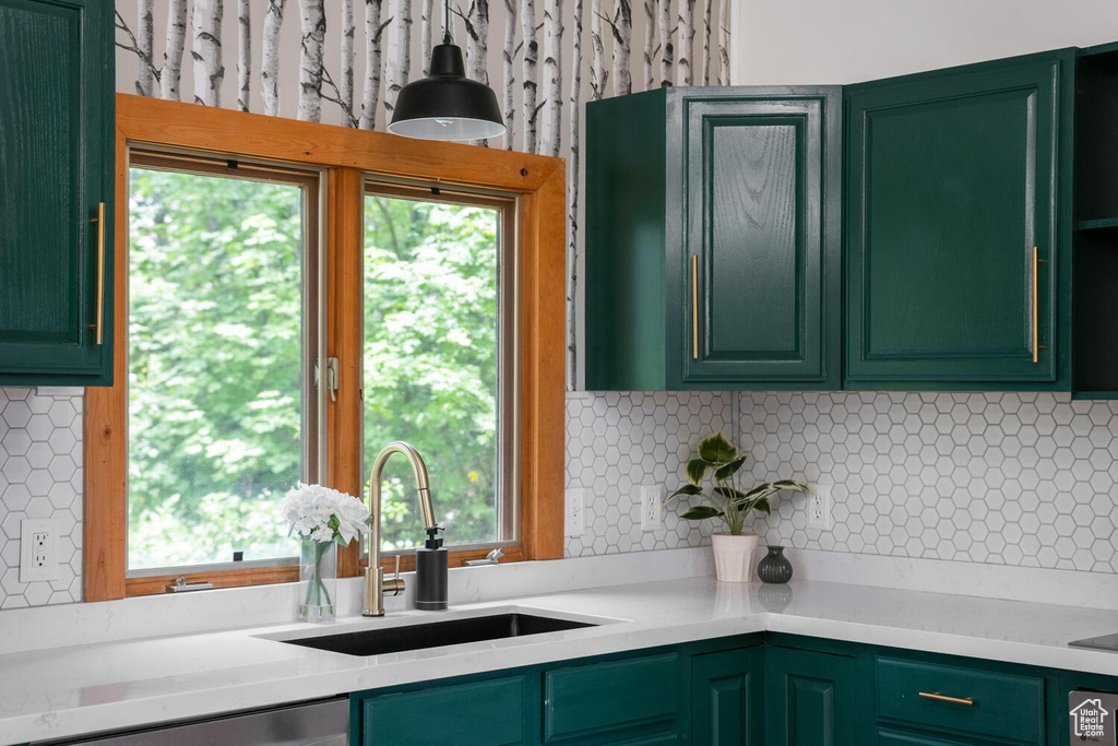 Kitchen with sink, tasteful backsplash, and green cabinets