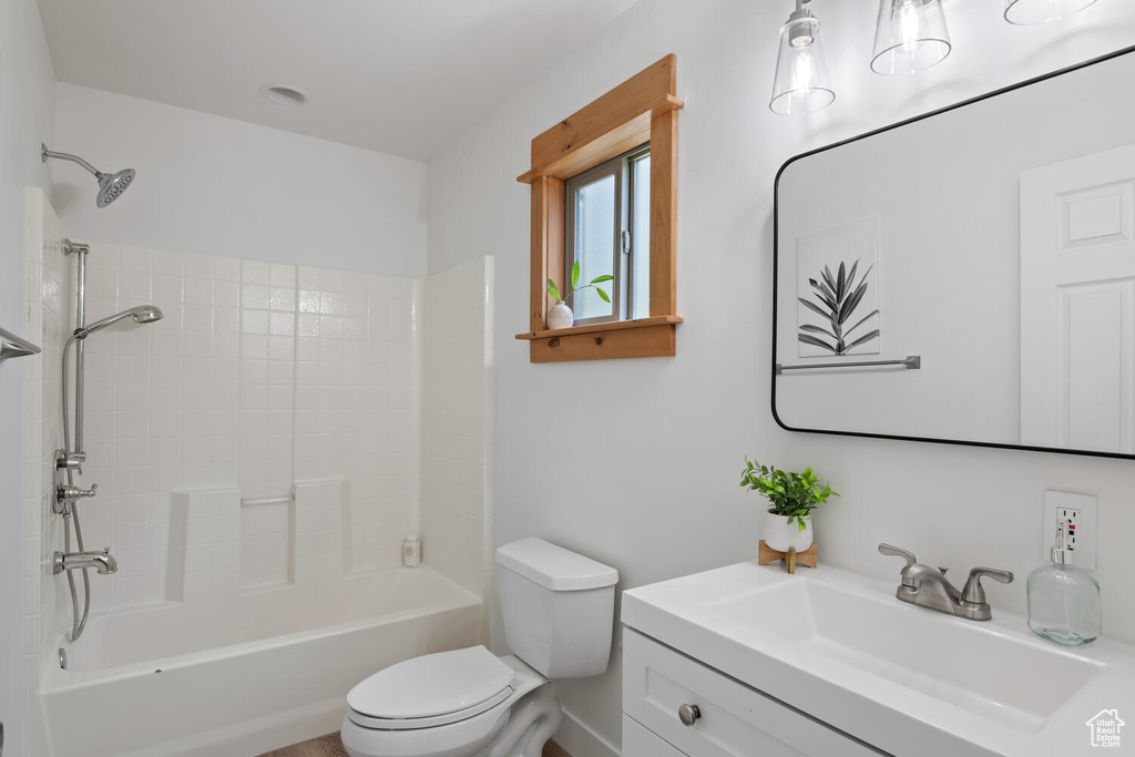 Full bathroom featuring bathing tub / shower combination, vanity, and toilet