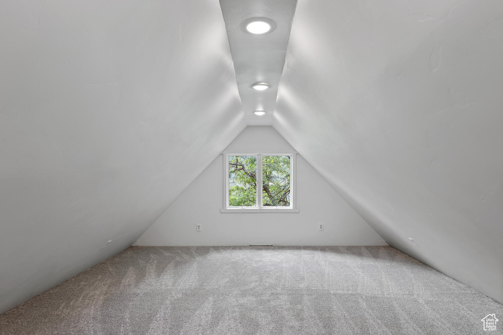 Bonus room featuring carpet and vaulted ceiling