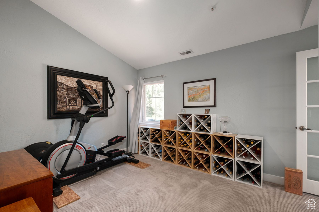 Interior space featuring carpet floors and vaulted ceiling