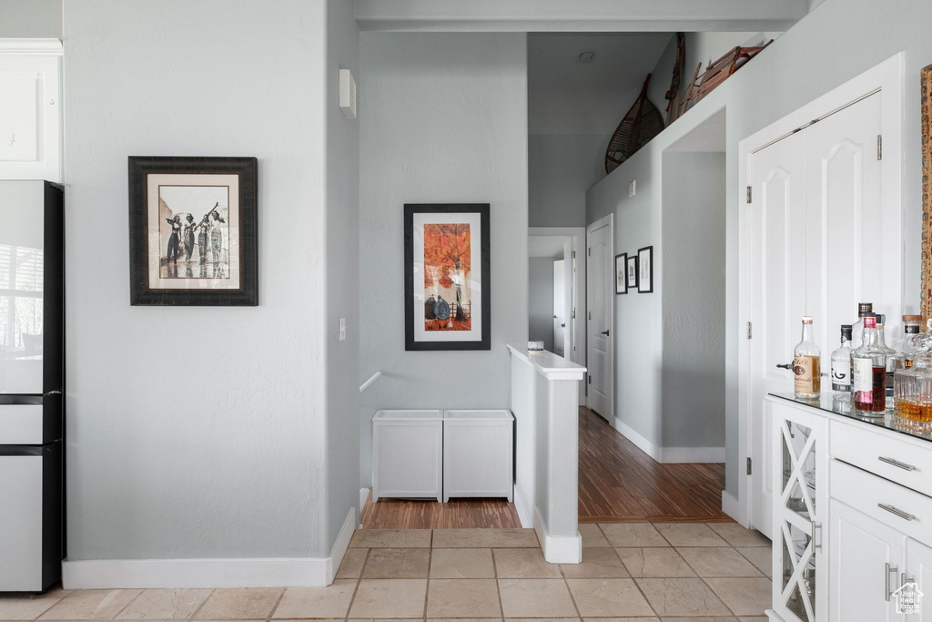 Hallway featuring light tile floors