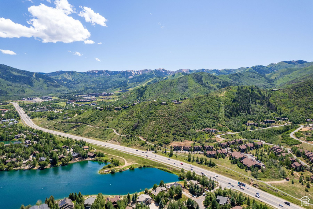 Drone / aerial view with a water and mountain view