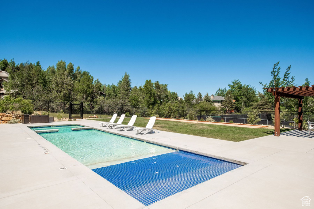 View of swimming pool with a pergola, a lawn, and a patio area