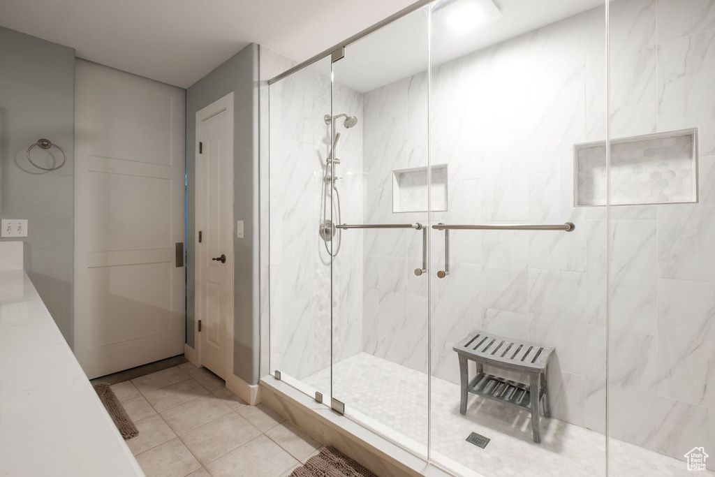 Bathroom featuring an enclosed shower and tile flooring