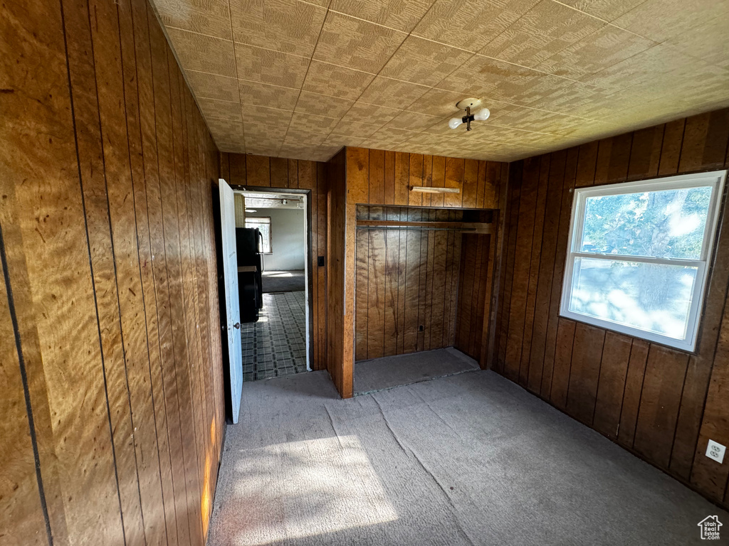 Hallway with wooden walls and carpet