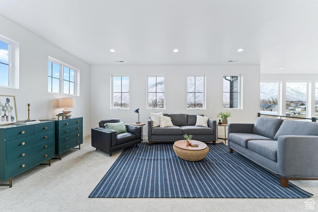 Living room with a healthy amount of sunlight and carpet