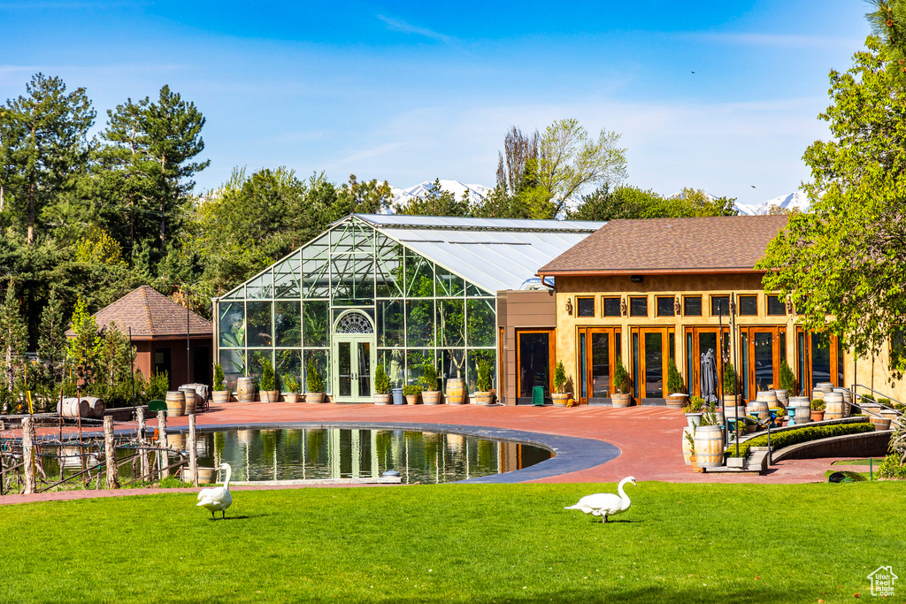 Back of property featuring a patio and a lawn