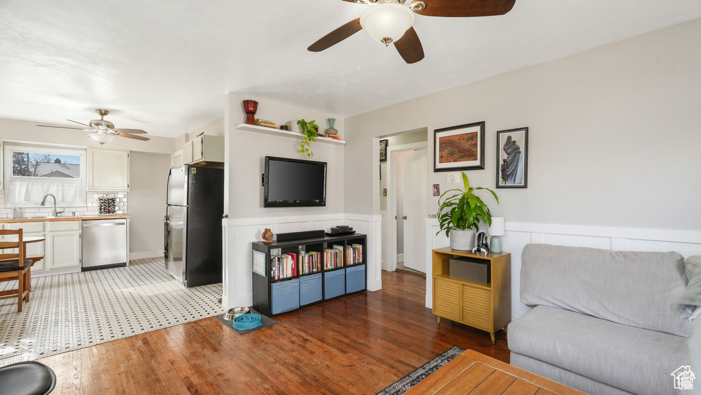 Living room with sink, ceiling fan, and tile floors