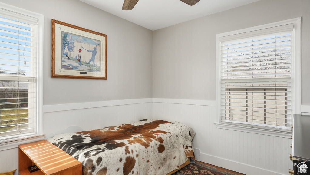 Bedroom featuring multiple windows and ceiling fan