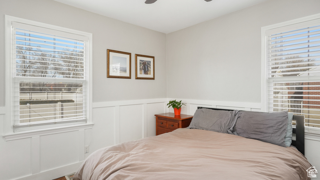 Bedroom featuring multiple windows and ceiling fan