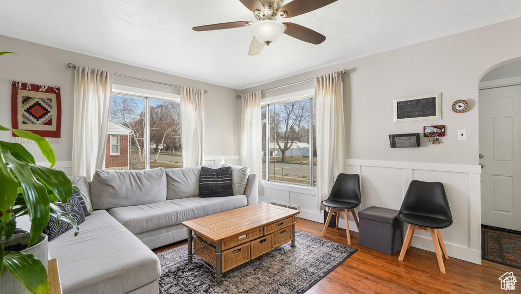 Living room with ceiling fan and hardwood / wood-style floors