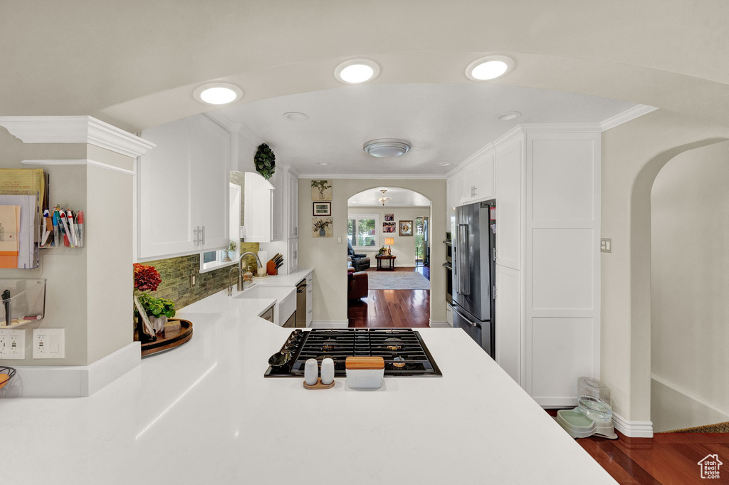 Kitchen with black gas stovetop, sink, high end refrigerator, and hardwood / wood-style floors