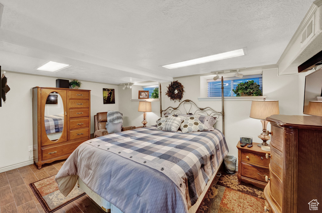 Bedroom featuring a textured ceiling and wood-type flooring