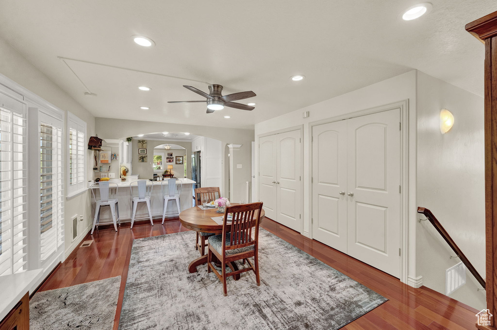 Dining area with ceiling fan and wood-type flooring