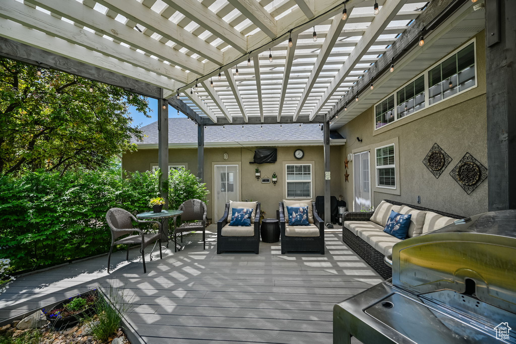 View of terrace featuring a pergola, an outdoor hangout area, and a wooden deck