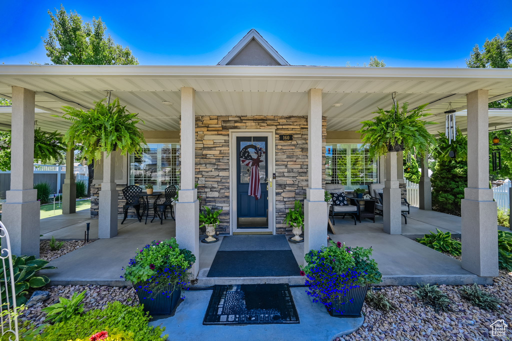 View of exterior entry featuring a porch