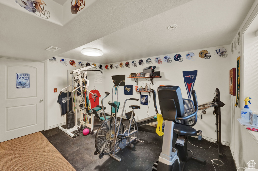 Workout room with a textured ceiling