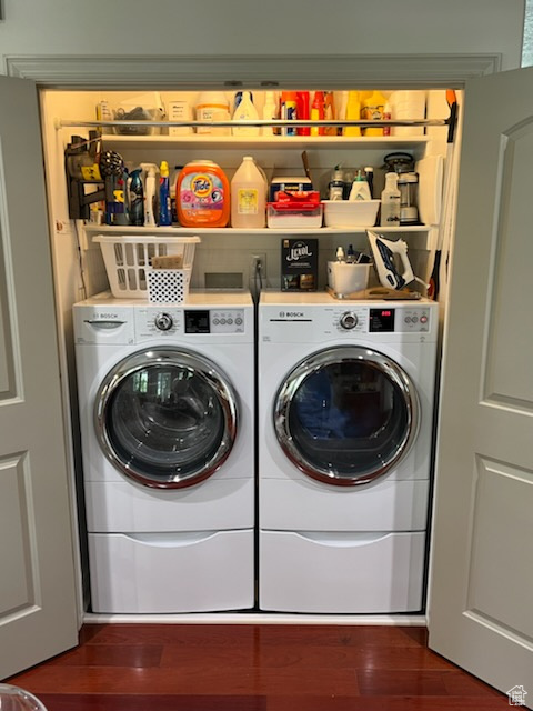 Laundry room featuring hardwood / wood-style floors and washing machine and dryer