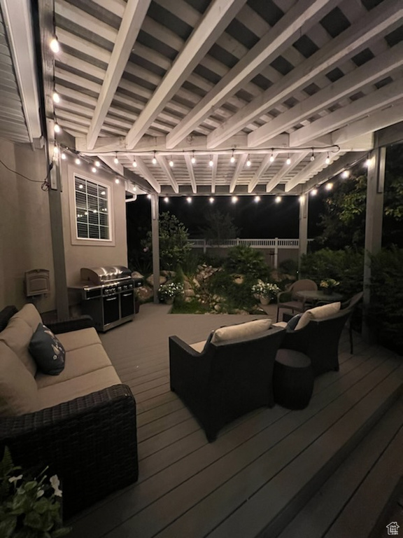 Wooden deck featuring outdoor lounge area, grilling area, and a pergola