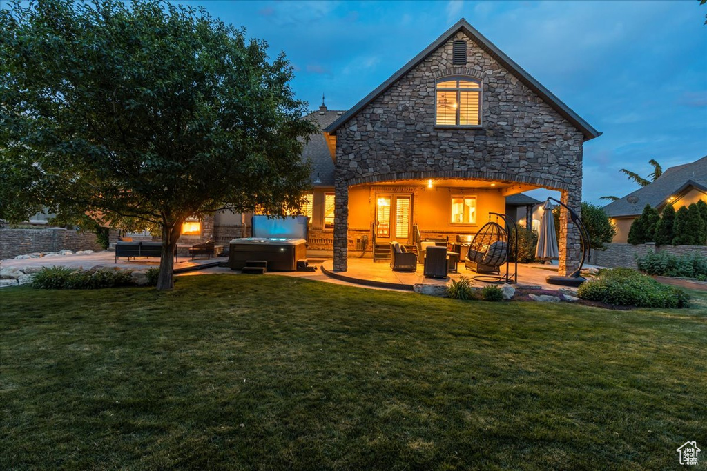 Rear view of house with outdoor lounge area, a patio area, and a yard