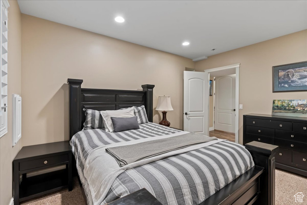 Bedroom featuring light colored carpet