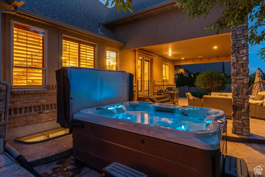 View of terrace featuring a hot tub