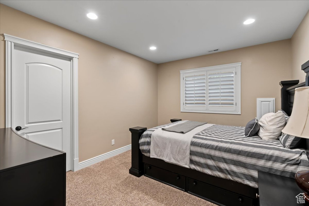 Bedroom with light colored carpet