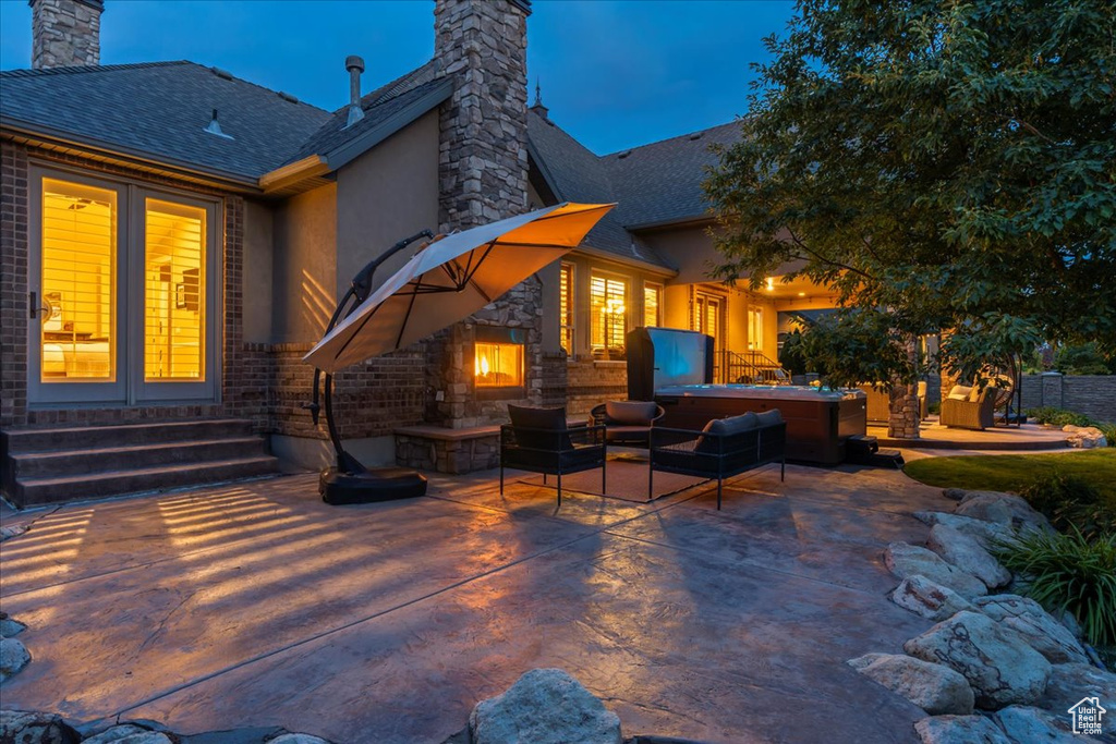 Back of house featuring an outdoor living space and a patio area