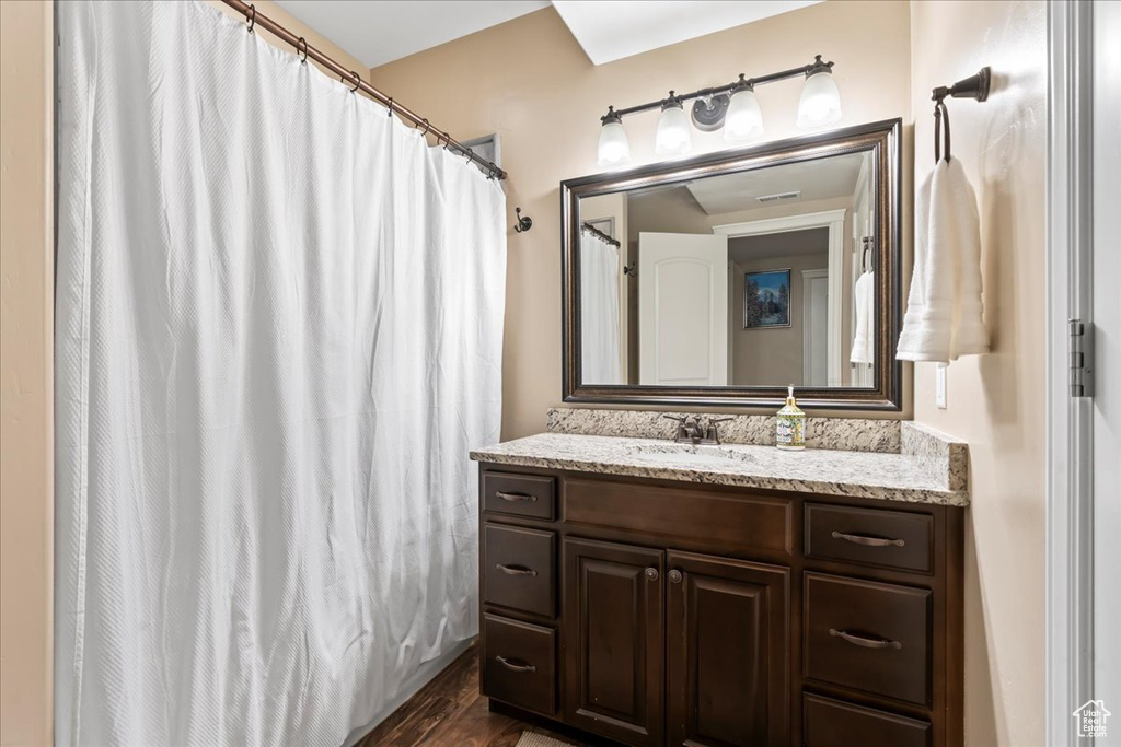 Bathroom with vanity and hardwood / wood-style flooring