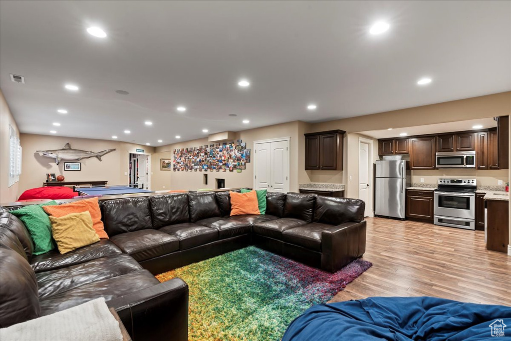 Living room with light hardwood / wood-style floors