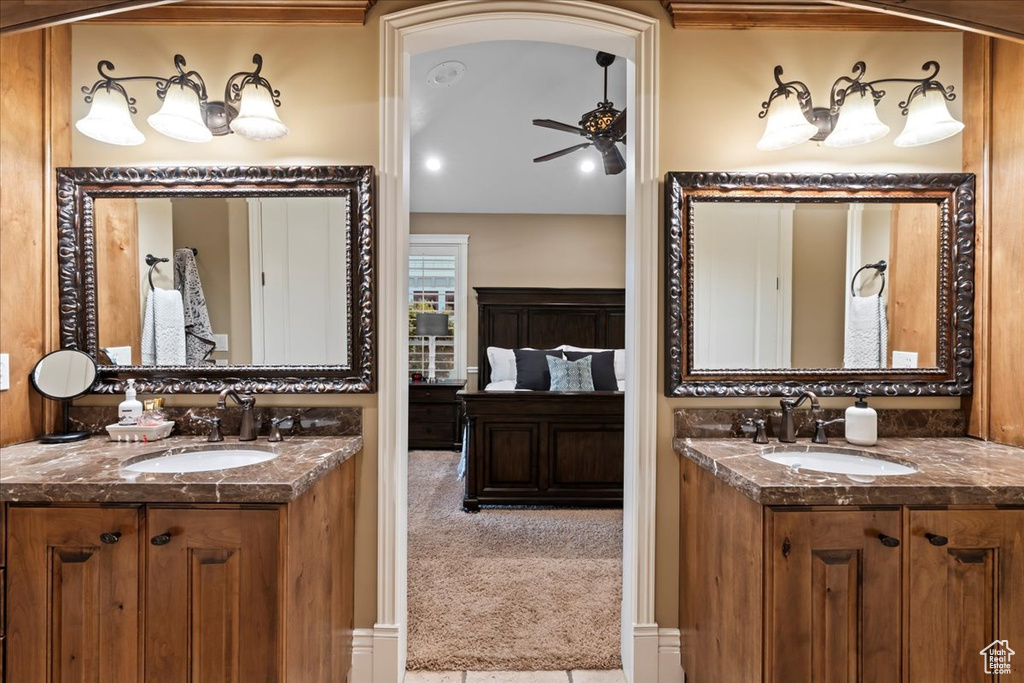 Bathroom featuring ceiling fan and double sink vanity