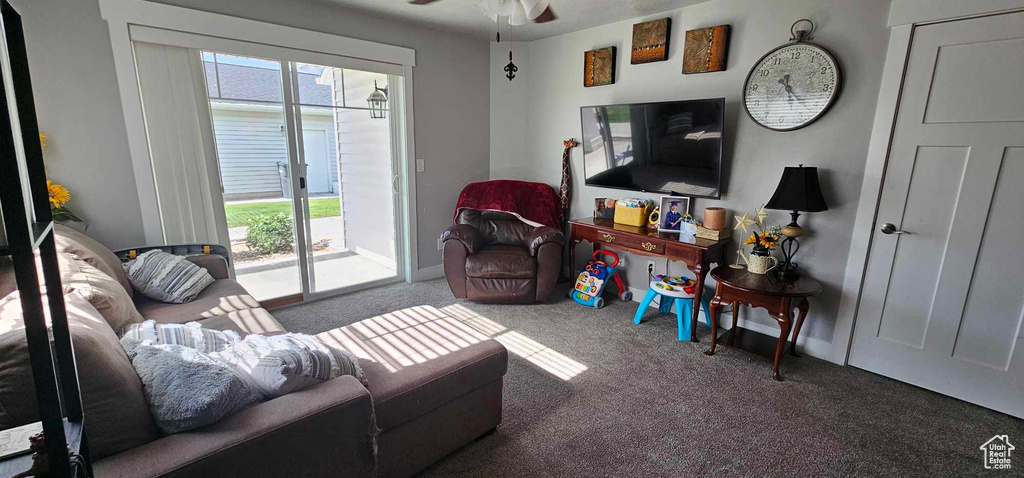 Carpeted living room with ceiling fan