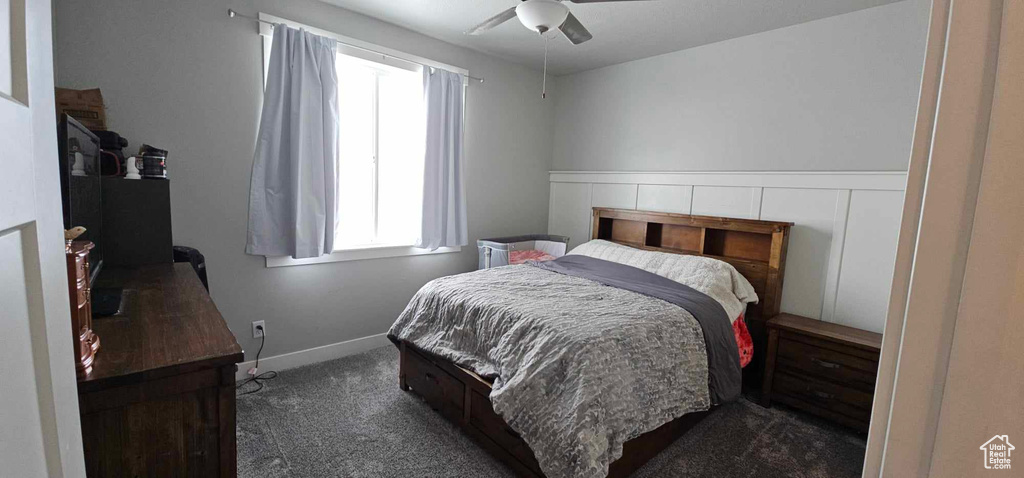 Carpeted bedroom with ceiling fan