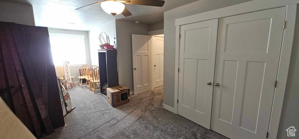 Bedroom featuring carpet flooring, a closet, and ceiling fan