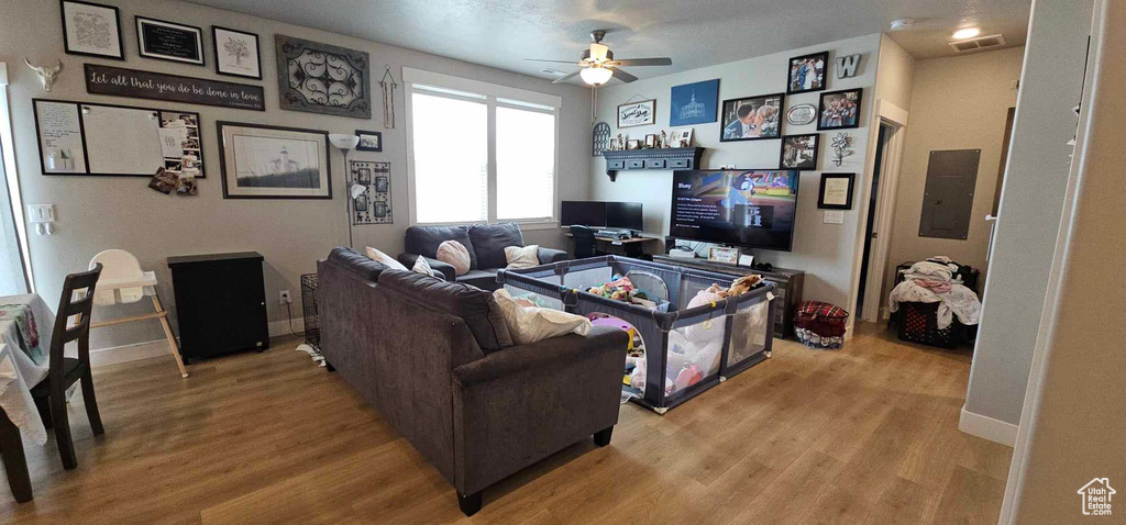 Living room featuring light hardwood / wood-style floors and ceiling fan