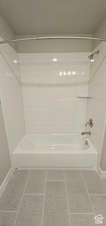 Bathroom featuring tile floors and tiled shower / bath combo