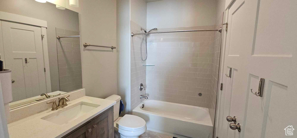 Full bathroom with vanity, toilet, and tiled shower / bath combo